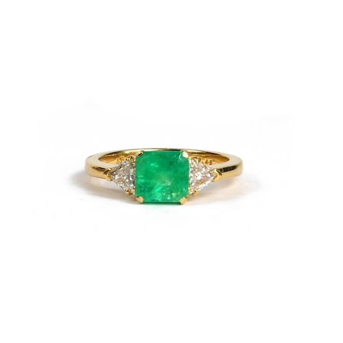 88A - AN 18CT YELLOW GOLD STEP CUT EMERALD AND TRILLIANT CUT DIAMOND THREE STONE RING.  (Emerald 1.45ct. D... 