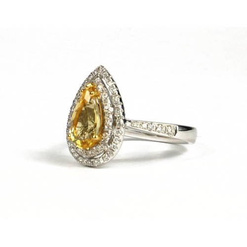 94A - AN 18CT WHITE GOLD PEAR SHAPE GOLDEN BERYL AND DIAMOND CLUSTER RING.  (Beryl 1.34ct. Diamonds 0.39ct... 