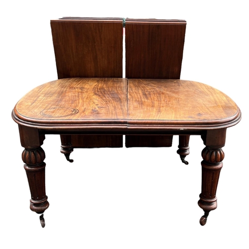 221 - A 19TH CENTURY SOLID MAHOGANY EXTENDING DINING TABLE
With two extra leaves, raised on bulbous and fl... 