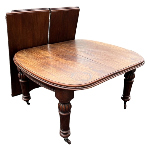 221 - A 19TH CENTURY SOLID MAHOGANY EXTENDING DINING TABLE
With two extra leaves, raised on bulbous and fl... 