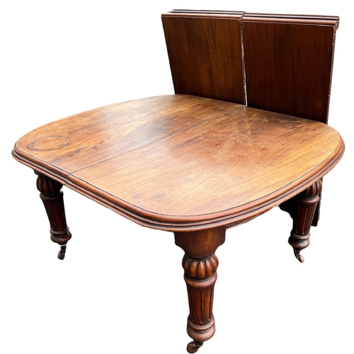 221 - A 19TH CENTURY SOLID MAHOGANY EXTENDING DINING TABLE
With two extra leaves, raised on bulbous and fl... 