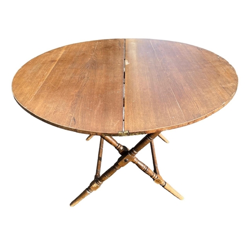 239 - A LATE 19TH CENTURY CIRCULAR MAHOGANY COACHING TABLE
The folding top, raised on ring turned legs joi... 