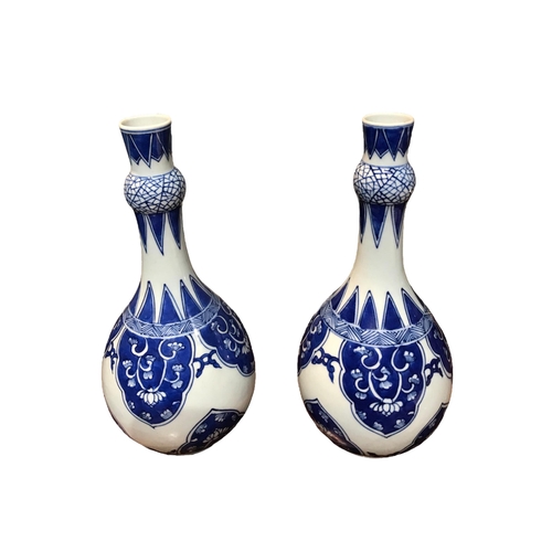 123 - A PAIR OF CHINESE BLUE AND WHITE SUANTOUPING GARLIC MOUTH SHAPED VASES
Decorated with geometric flor... 