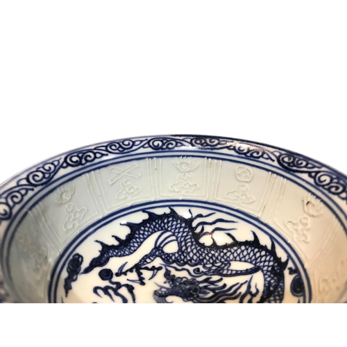 127 - A CHINESE BLUE AND WHITE STEM CUP 
Decorated interior showing a dragon chasing the pearl of wisdom, ... 