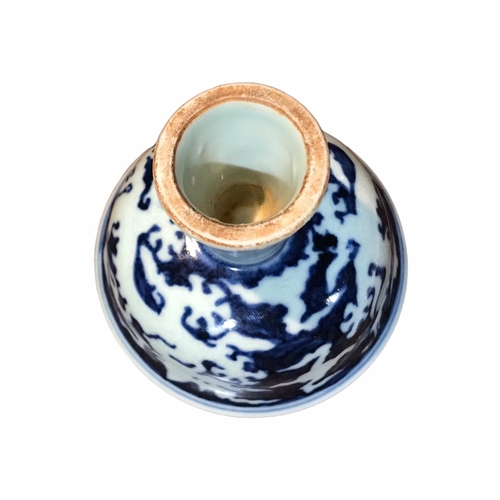 129 - A CHINESE BLUE AND WHITE STEM CUP 
Decorated with two dragons amongst clouds. 
(h 8.9cm x diameter 9... 