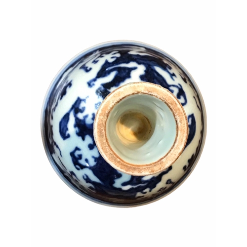 129 - A CHINESE BLUE AND WHITE STEM CUP 
Decorated with two dragons amongst clouds. 
(h 8.9cm x diameter 9... 