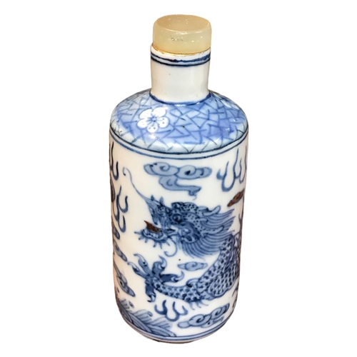 136 - A CHINESE BLUE AND WHITE PORCELAIN CYLINDRICAL SCENT BOTTLE 
Having a jade top stopper, decorated wi... 