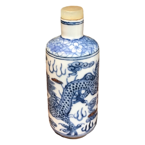 136 - A CHINESE BLUE AND WHITE PORCELAIN CYLINDRICAL SCENT BOTTLE 
Having a jade top stopper, decorated wi... 