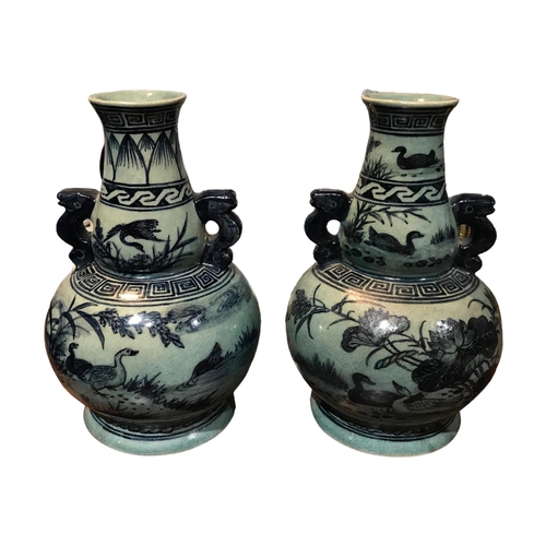 142 - A PAIR OF CHINESE MING STYLE VASES TOGETHER WITH A BLUE AND WHITE OPIUM POT VASES
Decorated with duc... 