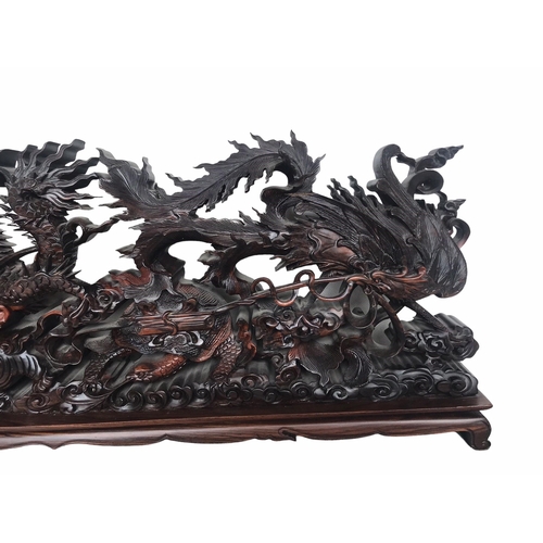 145 - A LARGE CHINESE CARVED HARDWOOD DEPICTING A DRAGON, PEACOCK, FO DOG AND
LÓNGGUĪ DRAGON TORTOISE.
(h ... 