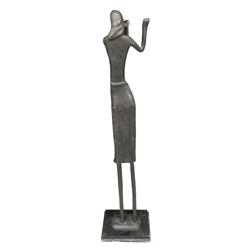 173 - AN EARLY 20TH CENTURY FLOOR STANDING ABSTRACT BRONZE SCULPTURE, A WOMAN PLAYING THE FLUTE.
(h 117.5c... 