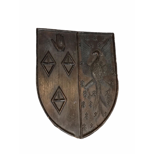 175 - AN 18TH CENTURY CARVED OAK SHIELD BEARING COAT OF ARMS
With an eagle facing left and three diamond s... 