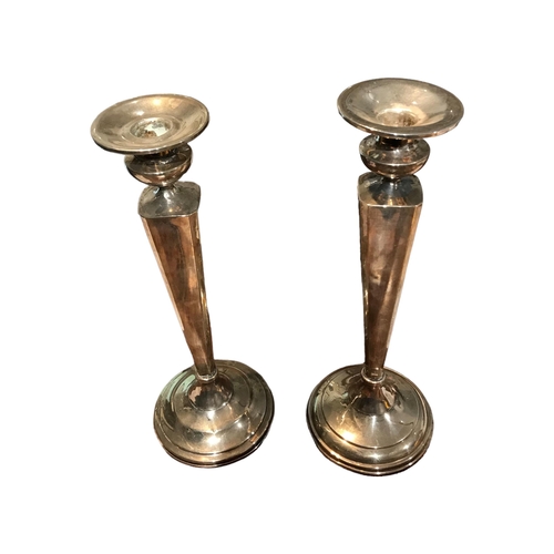 90b - DOMINICK & HAFF, 1869 - 1928, A PAIR OF AMERICAN STERLING SILVER CANDLESTICKS
Having ‘V’ shaped colu... 