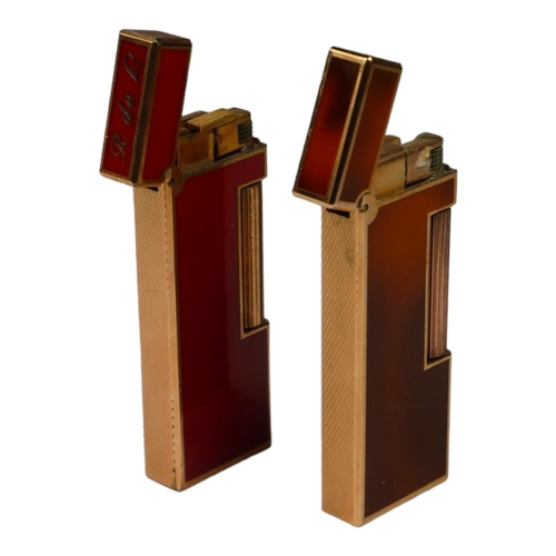 80 - DUNHILL, TWO VINTAGE GOLD PLATE AND ENAMEL CIGARETTE LIGHTERS
Rouge and brown enamel marked ‘105311’... 