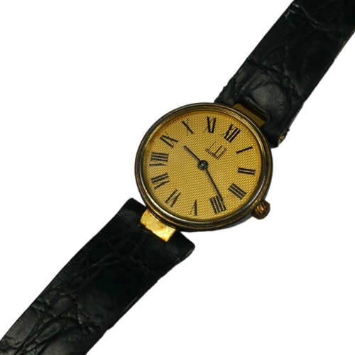 83 - DUNHILL, A SILVER GILT WRISTWATCH 
The circular gold tone dial with Roman number markings, on origin... 