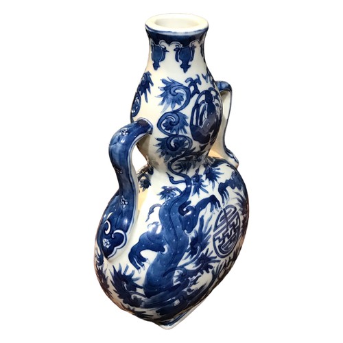 124 - A CHINESE BLUE AND WHITE BAOYUEPING MOON FLASK 
Decorated with two dragons encircling a Shou charact... 