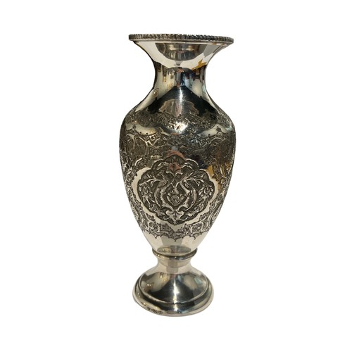 97c - A 20TH CENTURY PERSIAN/IRANIAN SILVER VASE 
Having four floral chased relief panels in between two s... 