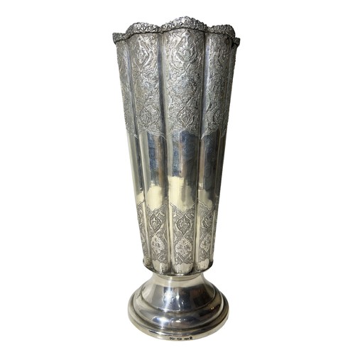 100b - AN IRANIAN/PERSIAN SILVER FLUTED VASE
Having chased floral relief to upper and lower body, raised on... 