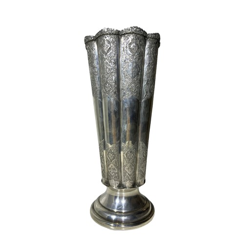 100b - AN IRANIAN/PERSIAN SILVER FLUTED VASE
Having chased floral relief to upper and lower body, raised on... 