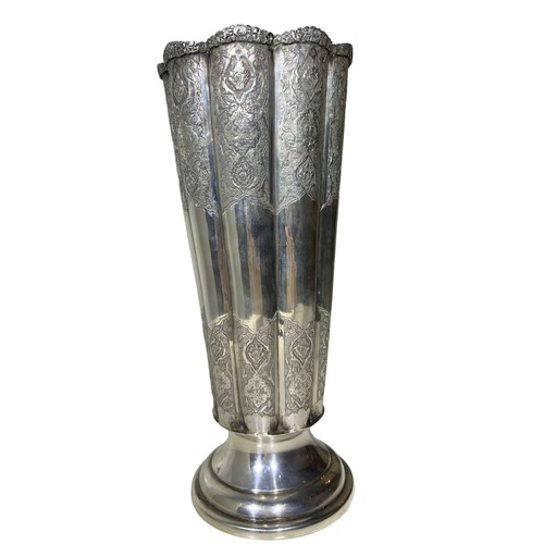 100b - AN IRANIAN/PERSIAN SILVER FLUTED VASE
Having chased floral relief to upper and lower body, raised on... 