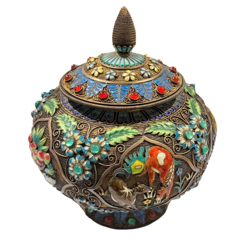 92c - A CHINESE TIBETAN SILVER GILT AND ENAMEL LIDDED POT
Decorated with filigree design, enamel flora and... 