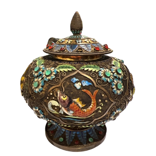 92c - A CHINESE TIBETAN SILVER GILT AND ENAMEL LIDDED POT
Decorated with filigree design, enamel flora and... 