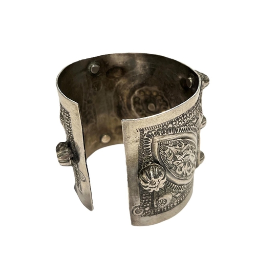 96c - A 19TH CENTURY ISLAMIC POSSIBLY LIBYAN SILVER BANGLE
Decorated geometric floral patterns with two pa... 