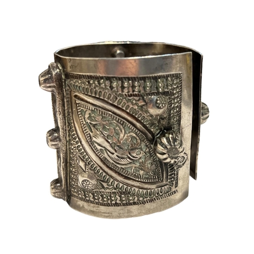 96c - A 19TH CENTURY ISLAMIC POSSIBLY LIBYAN SILVER BANGLE
Decorated geometric floral patterns with two pa... 