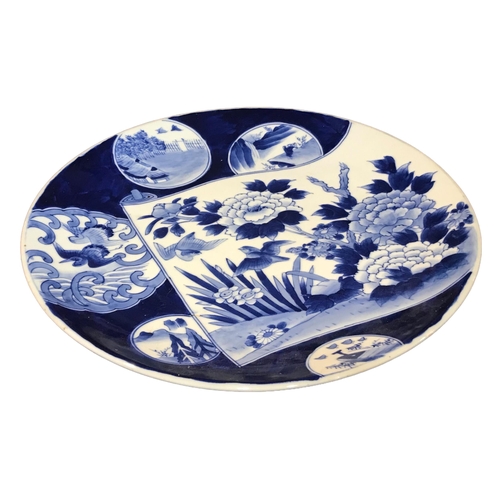 150 - A LARGE 19TH CENTURY JAPANESE BLUE AND WHITE CHARGER
Decorated with various depictions of birds, lan... 