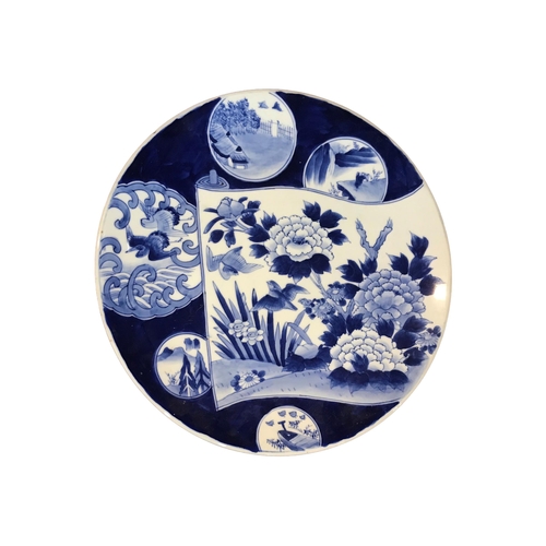 150 - A LARGE 19TH CENTURY JAPANESE BLUE AND WHITE CHARGER
Decorated with various depictions of birds, lan... 