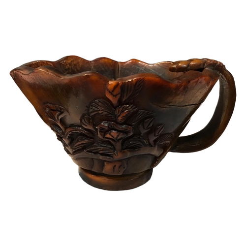 204 - A 19TH CENTURY CHINESE CARVED BUFFALO HORN LIBATION CUP
Having carved floral pine tree branches deco... 