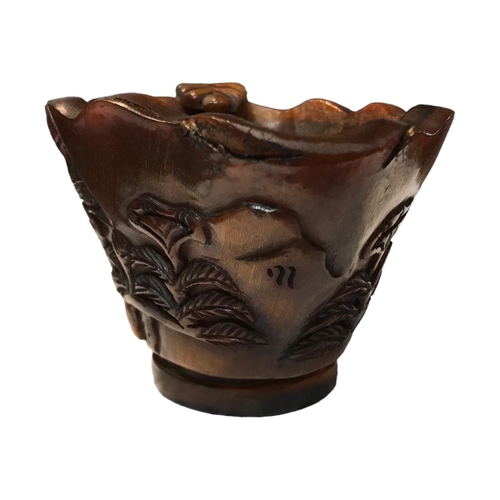 204 - A 19TH CENTURY CHINESE CARVED BUFFALO HORN LIBATION CUP
Having carved floral pine tree branches deco... 