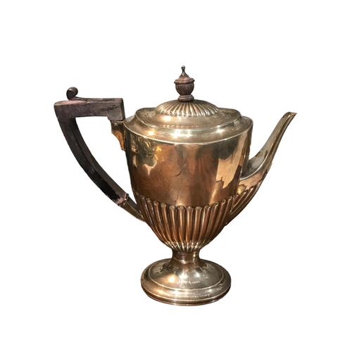 74c - A LATE VICTORIAN SILVER COFFEE POT
Having a wooden finial and thumb gripped handle, fluted body met ... 