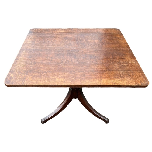 243a - A GEORGE III OAK TILT TOP BREAKFAST TABLE
The square top raised on turned a column and support, on t... 