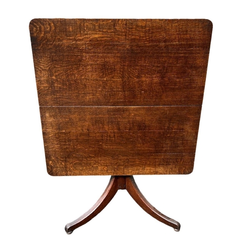 243a - A GEORGE III OAK TILT TOP BREAKFAST TABLE
The square top raised on turned a column and support, on t... 