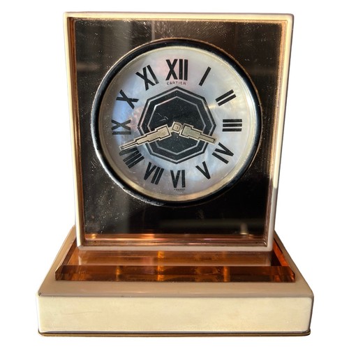 156 - CARTIER, PARIS, AN ART DECO MOTHER OF PEARL, ROSE GILDED METAL AND ENAMEL MIRRORED DESK CLOCK
The ci... 