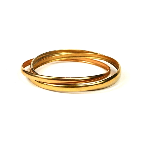 13 - A FRENCH 18CT TRICOLOURED GOLD TRINITY BANGLE.
(diameter 69mm, 17.9g)