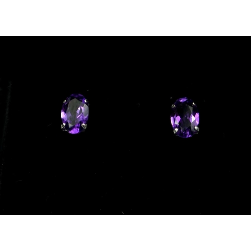 14 - A PAIR 18CT WHITE GOLD AMETHYST STUDS. (Approx Amethyst 0.80ct)