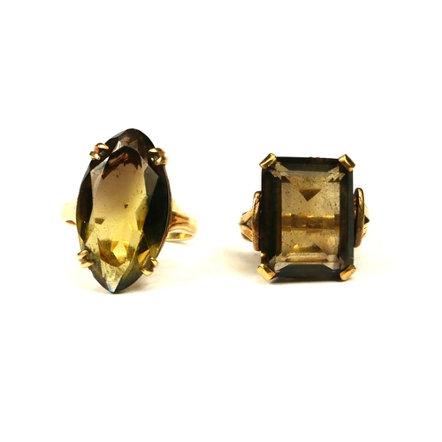 15 - TWO 9CT GOLD AND SMOKY QUARTZ RINGS.
(baguette cut ring size UK I½., navette cut ring size O. 10.8g)