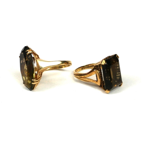 15 - TWO 9CT GOLD AND SMOKY QUARTZ RINGS.
(baguette cut ring size UK I½., navette cut ring size O. 10.8g)