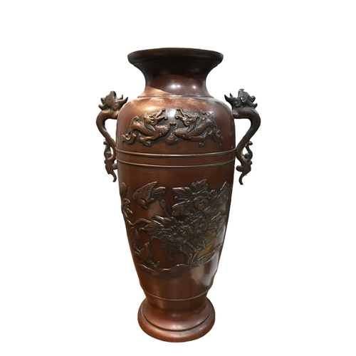 88 - A PAIR OF JAPANESE TWIN HANDLED BRONZE VASES
Decorated with dragons and birds amongst foliage. 
(h 2... 