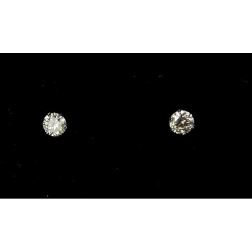2 - A PAIR 18CT WHITE GOLD SOLITAIRE DIAMOND STUDS. (Approx 0.20ct)
