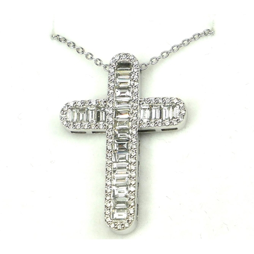 22 - AN 18CT WHITE GOLD BAGUETTE CUT DIAMOND CROSS with round brilliant diamond set edges on an 18ct whit... 