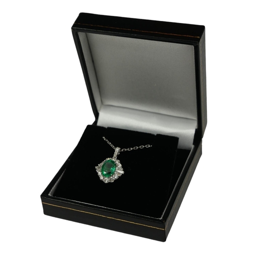 24 - AN 18CT WHITE GOLD OVAL EMERALD AND DIAMOND CLUSTER PENDANT on an 18ct white gold chain.  (Approx Em... 