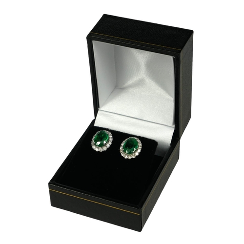26 - A PAIR 18CT WHITE GOLD OVAL EMERALD AND DIAMOND CLUSTER STUDS with WGI Certificate. (Emeralds 3.20ct... 
