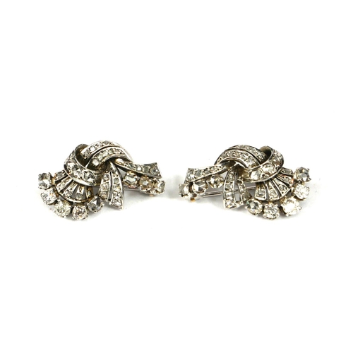 41 - A PAIR OF ART DECO WHITE METAL AND DIAMOND CLUSTER BROOCHES.
(tested for 18ct)
