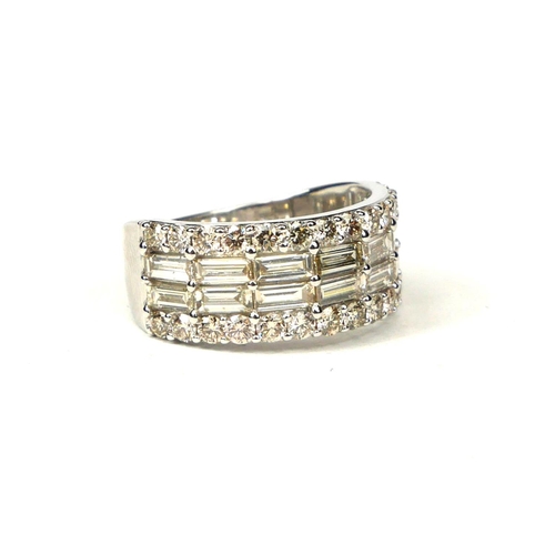 48 - A 9CT WHITE GOLD DIAMOND BAND set with baguette cut and round brilliant cut diamonds.  (Approx Diamo... 