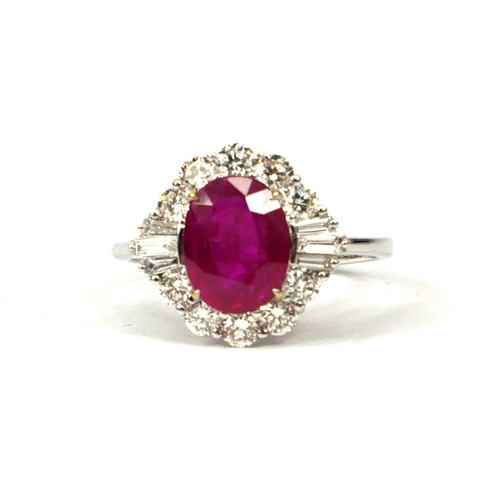 50 - 18CT WHITE GOLD OVAL RUBY AND DIAMOND CLUSTER RING.  (Approx. Ruby 2.05ct.  Diamonds 0.85ct)