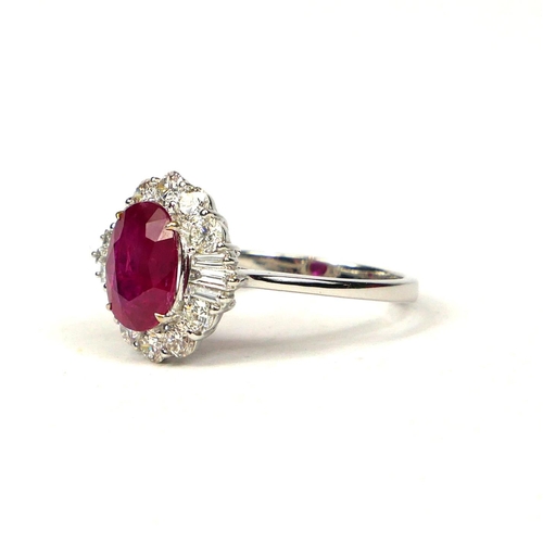 50 - 18CT WHITE GOLD OVAL RUBY AND DIAMOND CLUSTER RING.  (Approx. Ruby 2.05ct.  Diamonds 0.85ct)