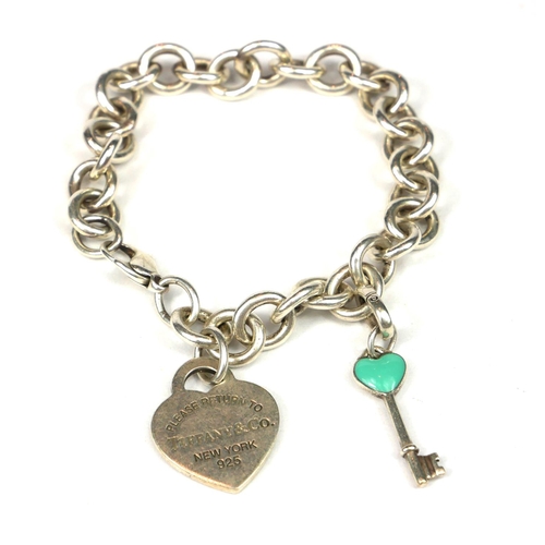 53 - TIFFANY & CO., NEW YORK, A SILVER BELCHER LINK CHARM BRACELET
Having heart form tag and key charm.
(... 